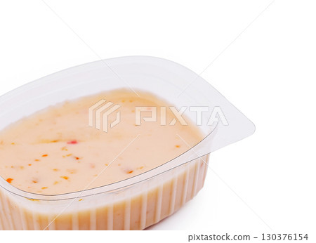 Creamy dip served in a plastic container with a rustic design Creamy dip served in a plastic container with a rustic design 130376154