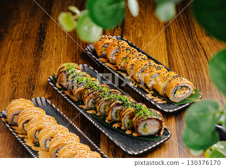 Delicious sushi rolls served on elegant plates at a restaurant setting Delicious sushi rolls served on elegant plates at a restaurant setting 130376170