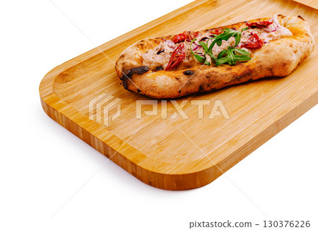 Delicious flatbread topped with cheese and herbs on a wooden tray 130376226