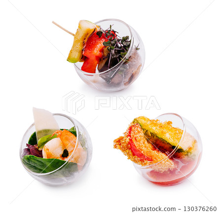 Colorful appetizers served in glass bowls at a modern culinary event 130376260