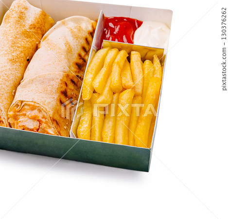 Delicious wrap and fries served in a takeout box with dips 130376262