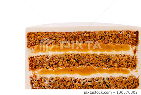Delicious carrot cake with cream cheese frosting and caramel layers on display 130376302