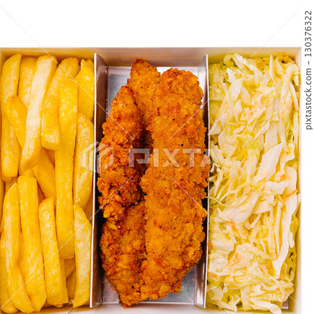 Crispy chicken tenders served with golden fries and fresh cabbage 130376322