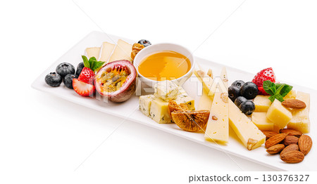 Delicious cheese platter with fruits and nuts perfect for any occasion Delicious cheese platter with fruits and nuts perfect for any occasion 130376327