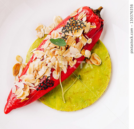 Savory stuffed pepper with almonds served on green tortilla Savory stuffed pepper with almonds served on green tortilla 130376356
