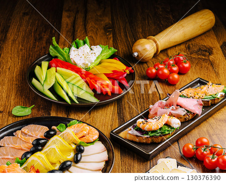 Colorful assortment of fresh seafood and vegetables on wooden table Colorful assortment of fresh seafood and vegetables on wooden table 130376390
