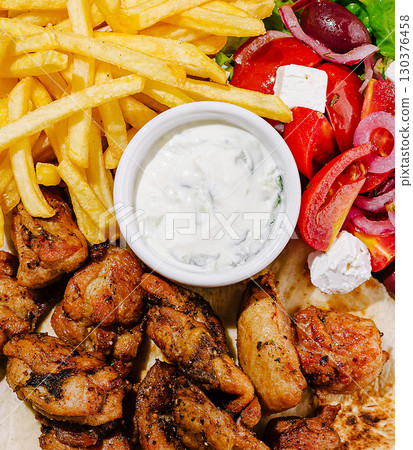 Delicious grilled chicken with fries and fresh salad served at local eatery Delicious grilled chicken with fries and fresh salad served at local eatery 130376458