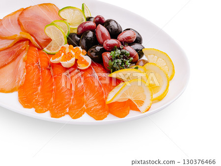 Salmon platter with citrus and olives presented on a white plate 130376466