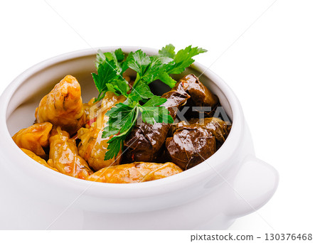 Delicious dolma stuffed grape leaves and regional delicacies served in a white bowl Delicious dolma stuffed grape leaves and regional delicacies served in a white bowl 130376468