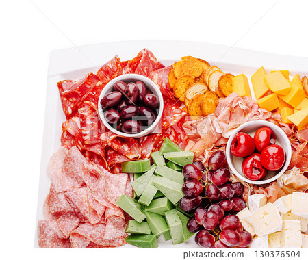 Assorted cheese and charcuterie platter with fresh fruits and olives 130376504