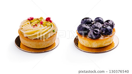 Delicious mini desserts featuring pistachio and blueberry toppings at bakery 130376540