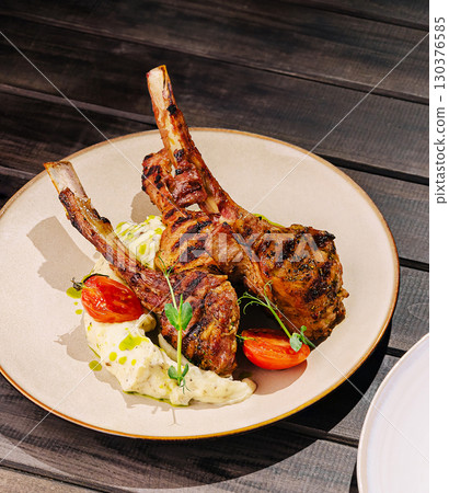 Grilled lamb chops served with creamy mashed potatoes and cherry tomatoes Grilled lamb chops served with creamy mashed potatoes and cherry tomatoes 130376585