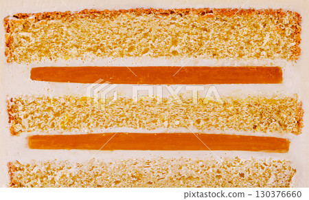 Layers of cake with vibrant orange filling displayed on a white background Layers of cake with vibrant orange filling displayed on a white background 130376660
