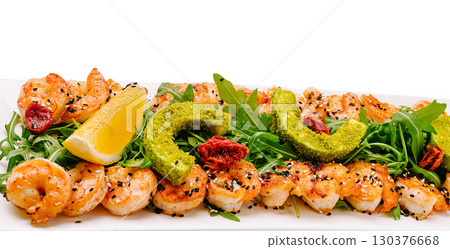 Seafood platter with shrimp and greens at a coastal eatery 130376668