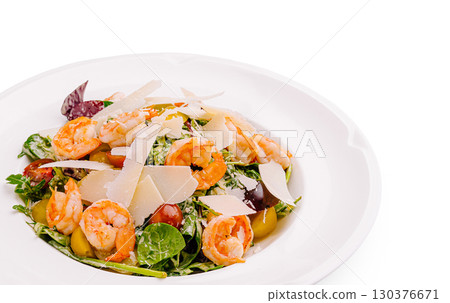 Colorful shrimp salad with greens, tomatoes, and cheese served on white plate Colorful shrimp salad with greens, tomatoes, and cheese served on white plate 130376671