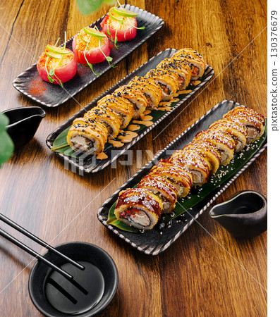 Sushi platters showcasing vibrant rolls and garnishes on stylish serving dishes Sushi platters showcasing vibrant rolls and garnishes on stylish serving dishes 130376679