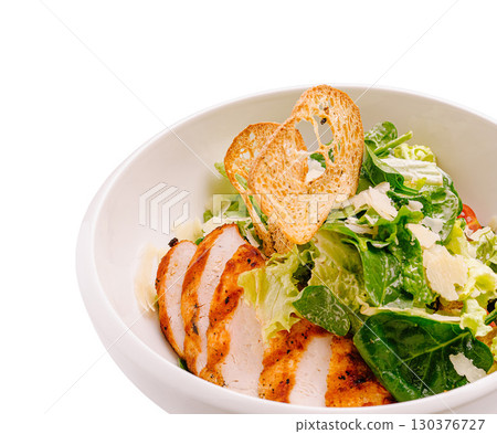 Delicious grilled chicken salad with fresh greens and toasted bread slices Delicious grilled chicken salad with fresh greens and toasted bread slices 130376727