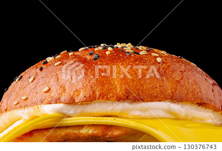 Delicious golden burger with melted cheese and sesame bun that tempts taste buds Delicious golden burger with melted cheese and sesame bun that tempts taste buds 130376743
