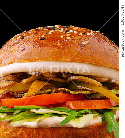 Delicious gourmet burger with fresh vegetables and savory toppings Delicious gourmet burger with fresh vegetables and savory toppings 130376745