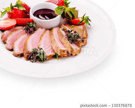 Deliciously plated duck breast with strawberries and sauce garnished elegantly 130376878