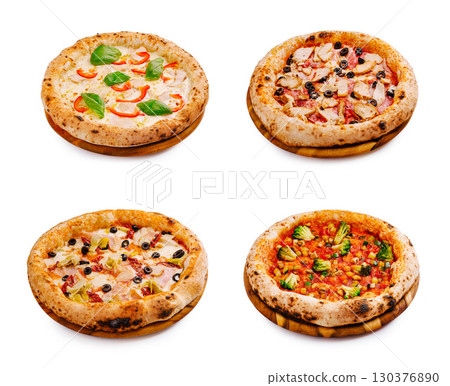 Freshly baked pizzas with assorted toppings on wooden plates 130376890