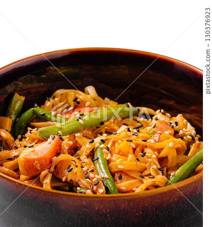 Delicious stir-fried noodles with vegetables and sesame seeds in bowl 130376923