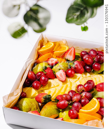 Fresh fruit platter featuring strawberries, grapes, and oranges for summer event 130376941