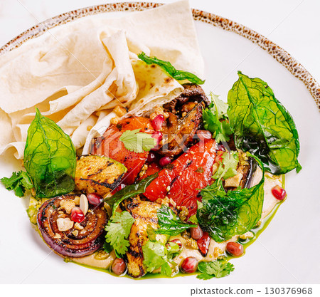 Colorful grilled vegetable salad served with flatbread for healt 130376968