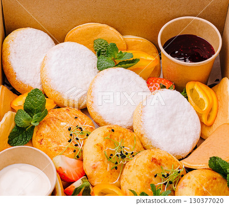 Delicious dessert selection with fruits and creamy toppings arranged beautifully Delicious dessert selection with fruits and creamy toppings arranged beautifully 130377020