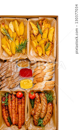 Delicious assortment of grilled meats and crispy potato wedges for sharing 130377034