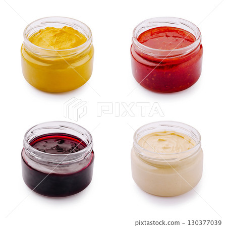 Variety of condiments or sauces displayed in jars, perfect for enhancing meals Variety of condiments or sauces displayed in jars, perfect for enhancing meals 130377039