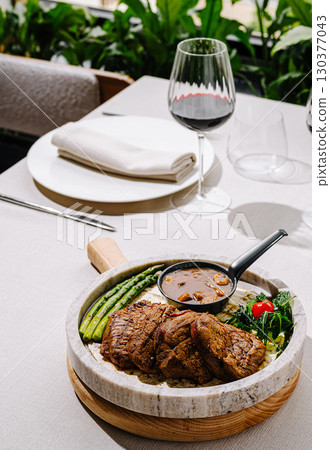 Delicious grilled steak with vegetables served in an elegant dining setting 130377043