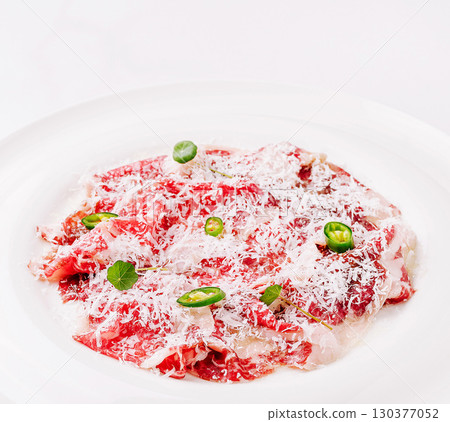 Deliciously prepared beef dish garnished with herbs and spices 130377052