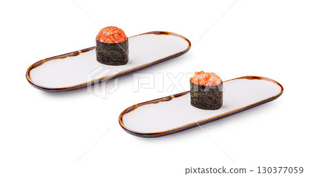 Exquisite sushi rolls presented on elegant plates in a minimal setting 130377059