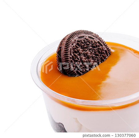 Dessert with caramel sauce and chocolate cookie topping served in a cup Dessert with caramel sauce and chocolate cookie topping served in a cup 130377060