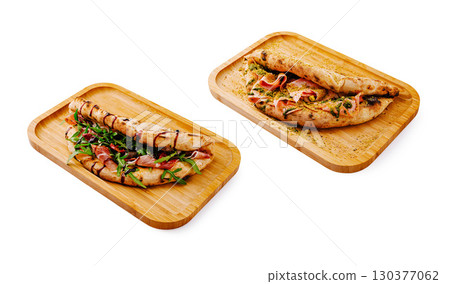 Delicious flatbreads served with fresh toppings on wooden trays 130377062
