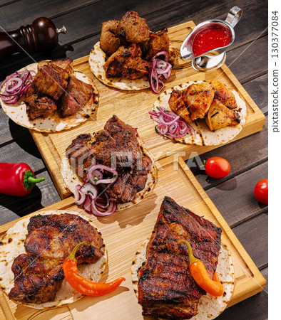 Delicious grilled meats served on tortillas with fresh toppings Delicious grilled meats served on tortillas with fresh toppings 130377084