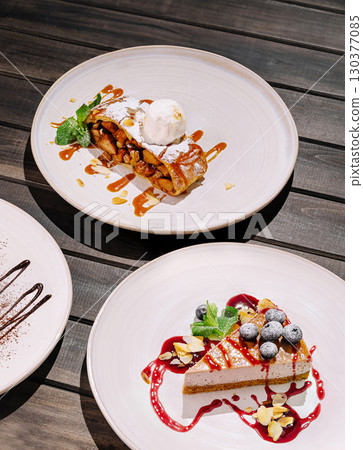 Delicious dessert platter featuring cheesecake and fruit-filled pastry 130377085