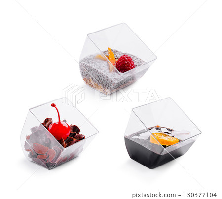 Unique dessert cups filled with colorful treats display in a kitchen setting 130377104