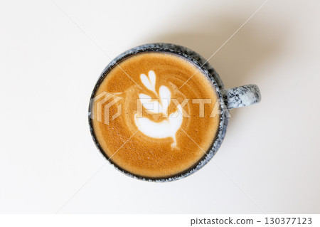 Close up shot of hot coffee latte art on wood table in cafe 130377123