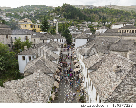 Aerial Top view Drone Shot of the central streets in Gjirokastra, Albania. Crowded Center, Souvenir shop, Cafe, Tourist Aerial Top view Drone Shot of the central streets in Gjirokastra, Albania. Crowded Center, Souvenir shop, Cafe, Tourist 130377228