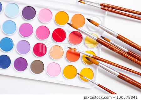 Vibrant watercolor palette with paintbrushes on white background Vibrant watercolor palette with paintbrushes on white background 130379841