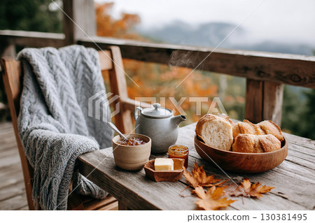 Enjoying a slow breakfast on a rustic terrace surrounded by autumn colors 130381495