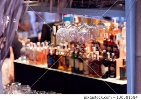 Close-up of clean wine glasses hanging in a bar 130381584