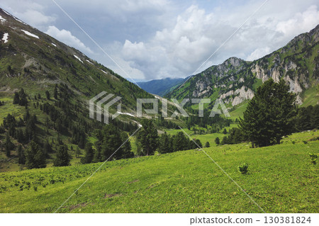 Distant sunny mountain valley. Summertime. 130381824