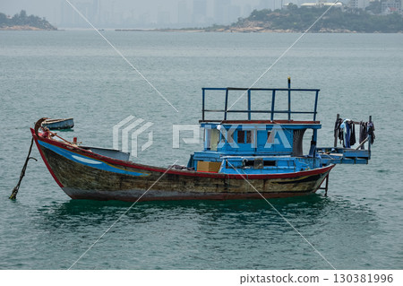 Fishing boats are floating in the sea. Traditional Fishing Vietnamese Boat. Boats near Nha Trang Vietnam. Fishing industry. Travel photo, nobody Fishing boats are floating in the sea. Traditional Fishing Vietnamese Boat. Boats near Nha Trang Vietnam. Fishing industry. Travel photo, nobody 130381996