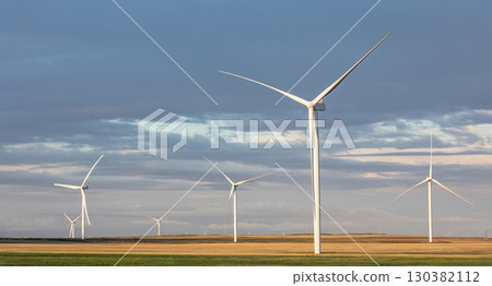 Wind turbine generators for sustainable electrical energy production. Panoramic view of windmills in a rural area during sunset. Sustainable , renewable energy green technology industry 130382112