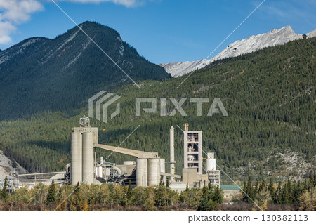 Cement Plants manufacturing in Canada. Industrial cement plant Lafarge Exshaw in Alberta, Canada. Mountain view in autumn. Travel photo. 130382113
