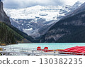 Red boats for tourists at the deck on Lake Louise in Banff National Park, Alberta, Canada. Glacial lake with turquoise water in the Canadian Rockies. Travel photo, nobody 130382235