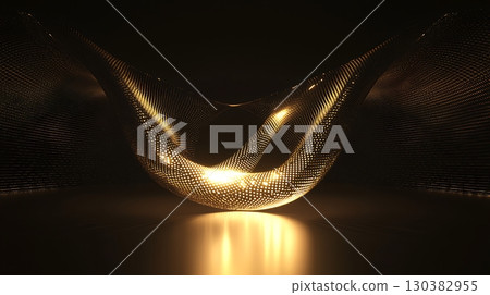 A gold object with a curved shape is lit up in a dark room 130382955
